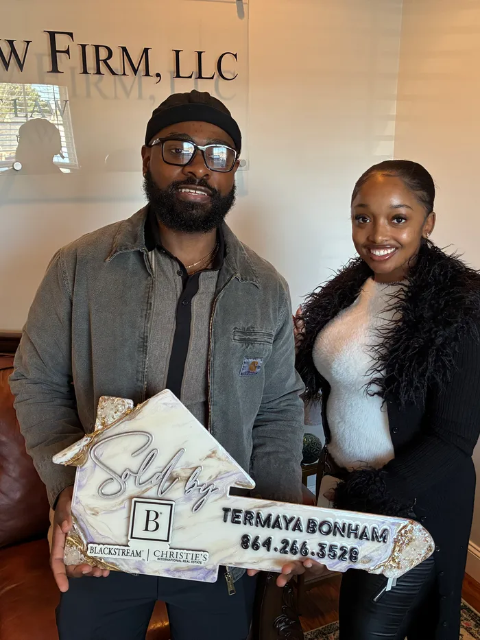 Darnell holding Termaya&rsquo;s branded key at his closing