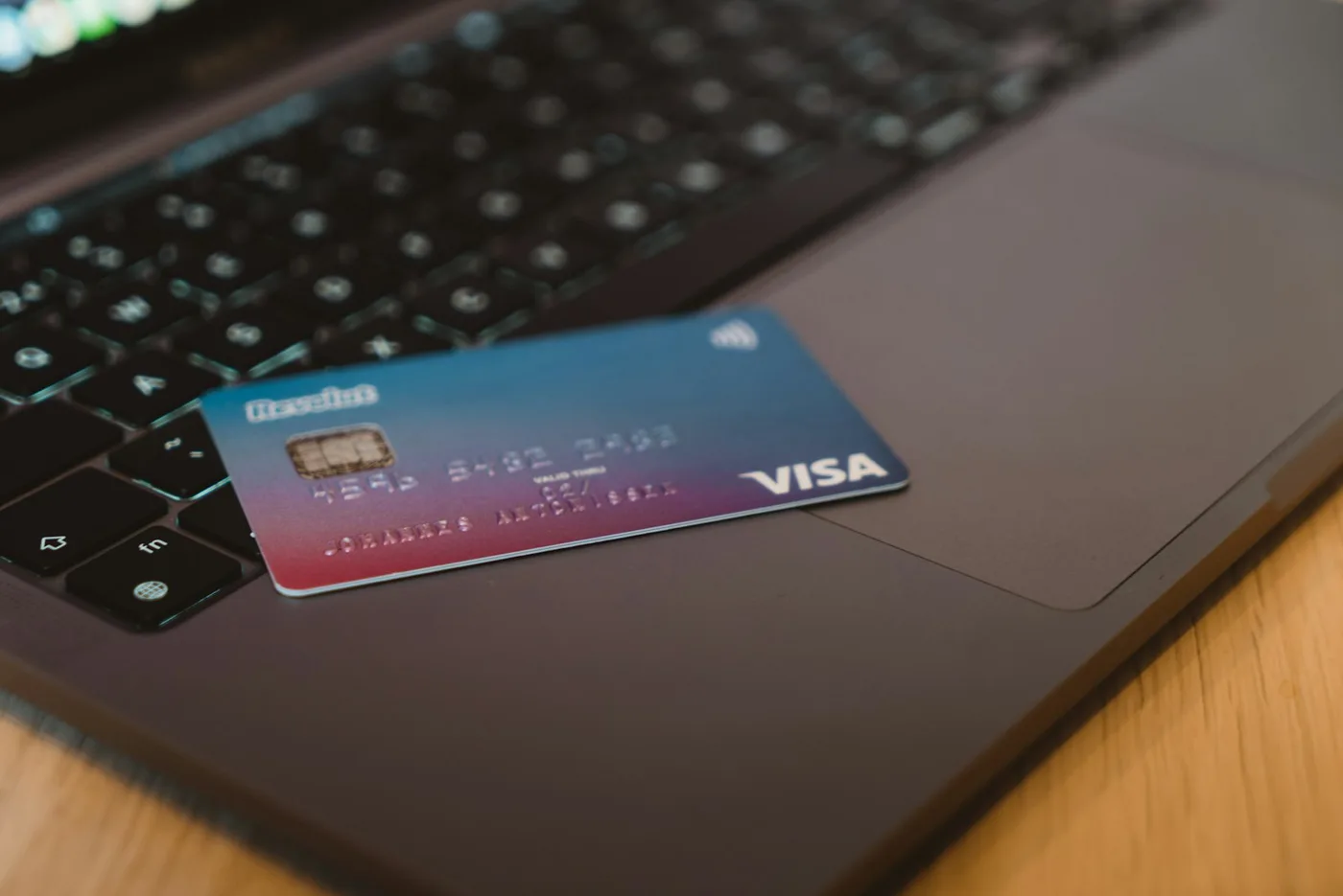 A credit card resting on a laptop, representing the CreditLikes credit-improvement platform